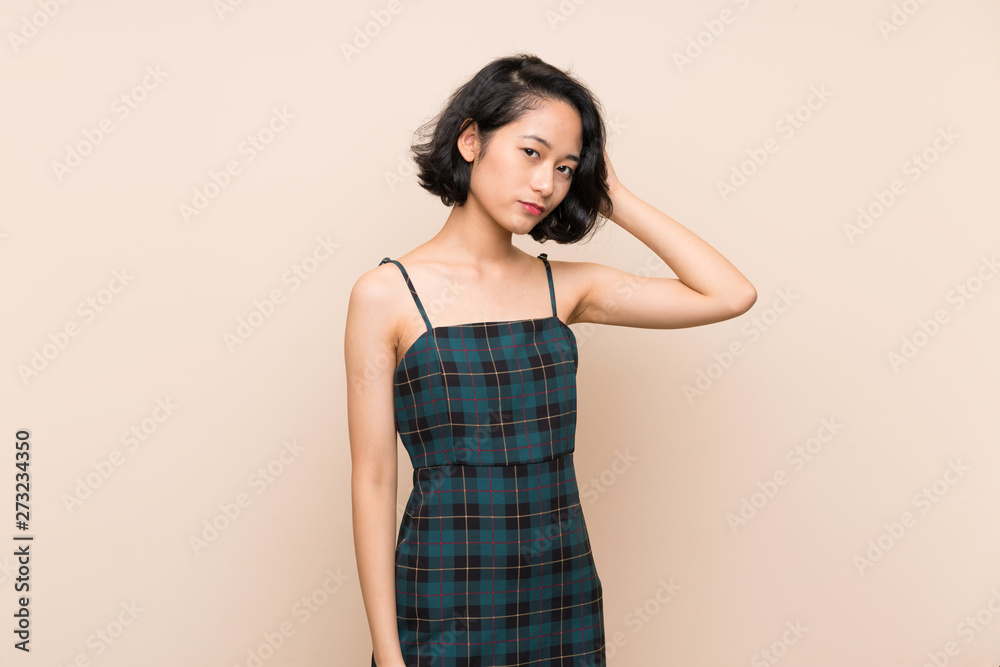 Asian young woman over isolated yellow wall with an expression of frustration and not understanding Asian young woman over isolated yellow wall with an expression of frustration and not understanding