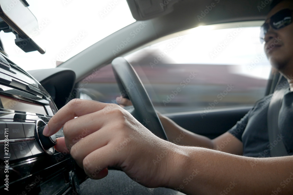 Driver's Hand Press Button on Car Radio Driver's Hand Press Button on Car Radio