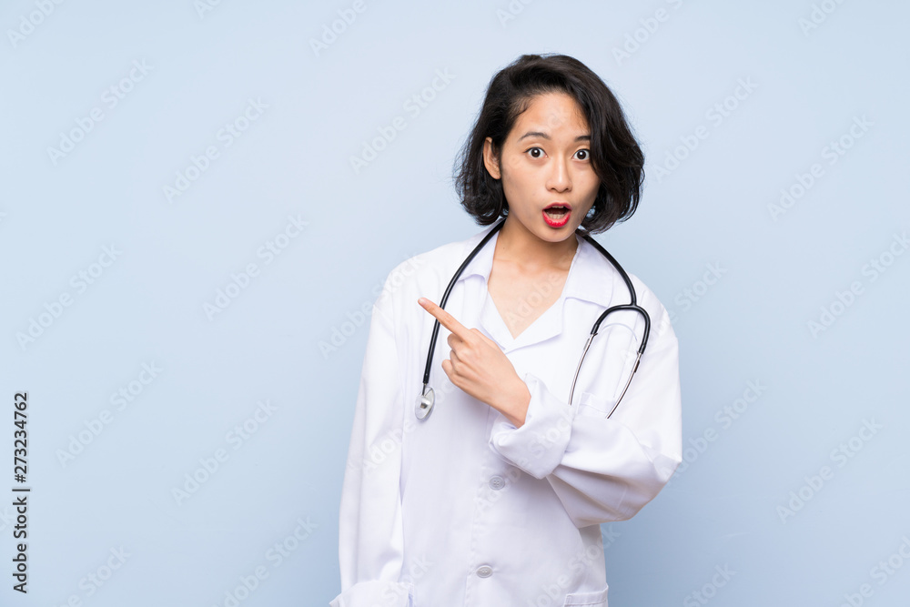 Doctor Asian woman surprised and pointing side Doctor Asian woman surprised and pointing side