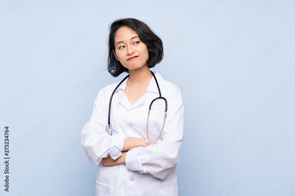 Doctor Asian woman making doubts gesture while lifting the shoulders Doctor Asian woman making doubts gesture while lifting the shoulders