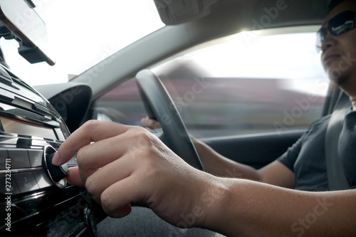 Driver's Hand Press Button on Car Radio © airdone