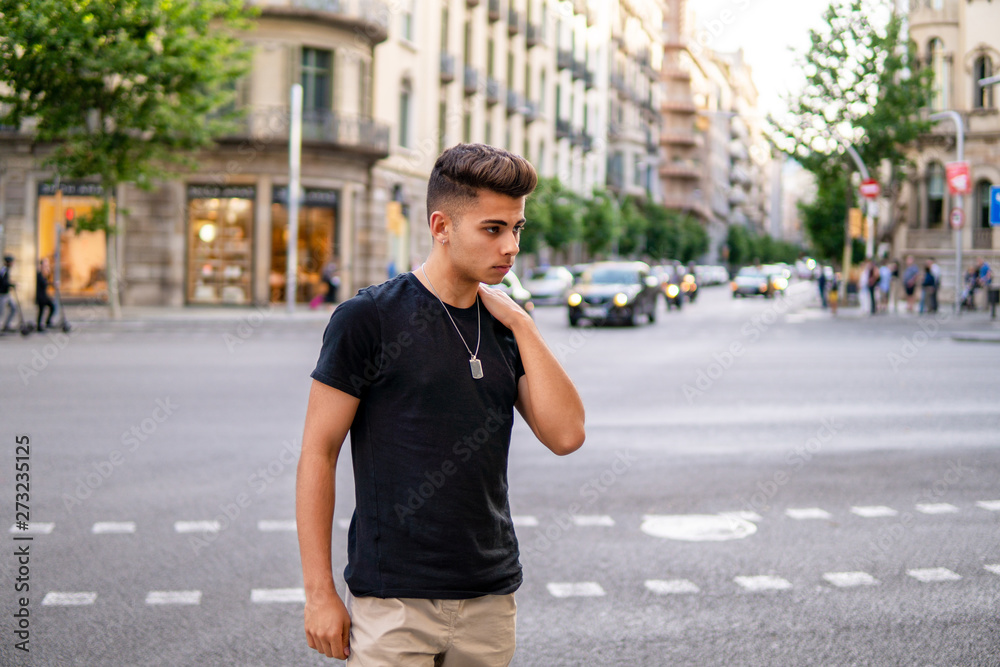 Young fashionable handsome man on the street of modern city. He looks sad Young fashionable handsome man on the street of modern city. He looks sad
