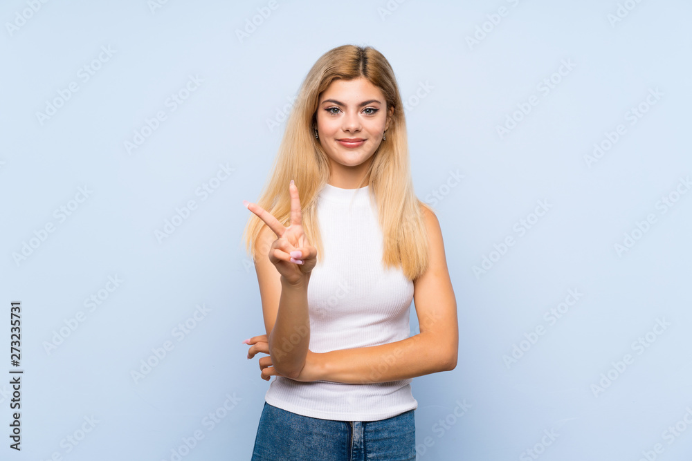Teenager girl over isolated blue background thinking an idea while looking up Teenager girl over isolated blue background thinking an idea while looking up