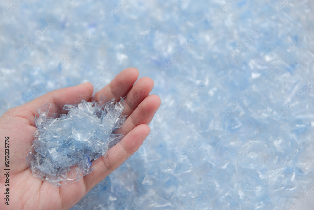 Woman hand holding Bottle flake,PET bottle flake,Plastic bottle crushed