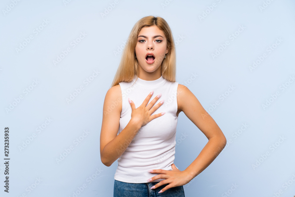 Teenager girl over isolated blue background with neckache Teenager girl over isolated blue background with neckache
