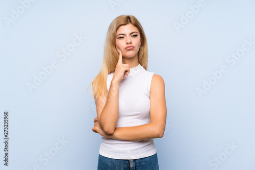 Teenager girl over isolated blue background counting ten with fingers © luismolinero