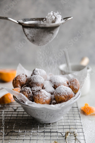 Powdered sugar dusting over cara cara fritters
