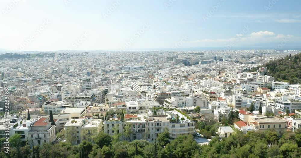 Tilt-up from the still drone to the houses apartment buildings real estate of Athens city capital of Greece and Aegean Sea Saronic Gulf warm sunny day Tilt-up from the still drone to the houses apartment buildings real estate of Athens city capital of Greece and Aegean Sea Saronic Gulf warm sunny day