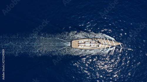 Aerial photo of beautiful luxury sail boat with wooden deck cruising the deep blue Aegean sea, Greece © aerial-drone