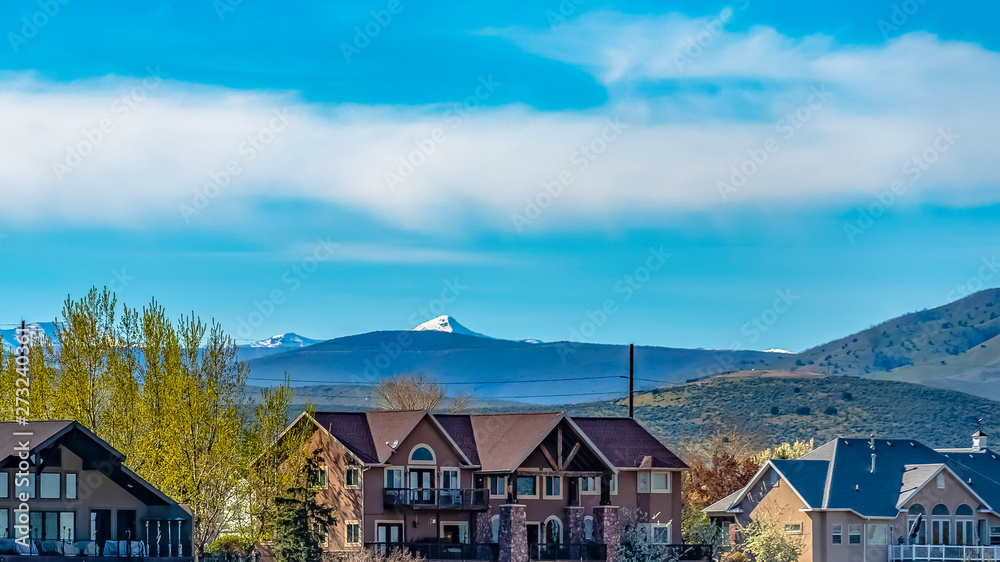 Panorama frame Facade of beautiful homes with mountains and cloudy blue sky background