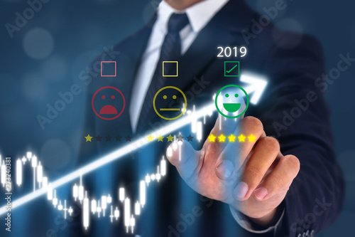 2019 man point hand to the  happy face satisfication with bussiness experiance with graph growth in year 2019 photo