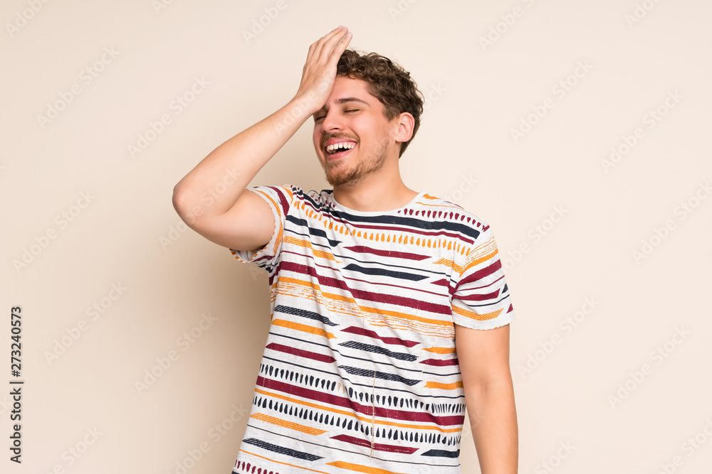 Blonde man over isolated wall has realized something and intending the solution Blonde man over isolated wall has realized something and intending the solution