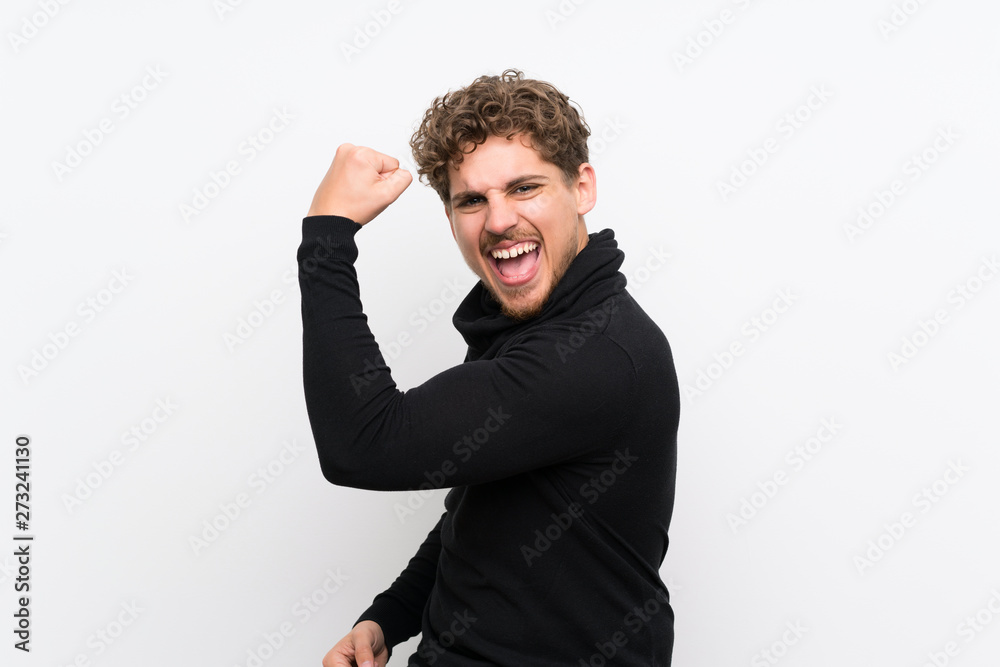 Blonde man over isolated white wall doing strong gesture Blonde man over isolated white wall doing strong gesture