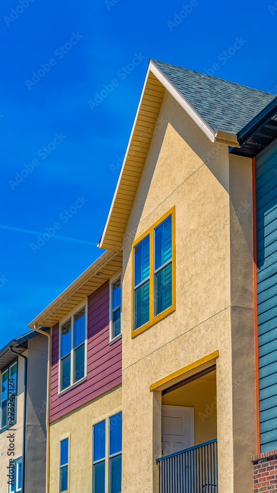 Vertical Exterior view of houses with balcony and multi colored wall