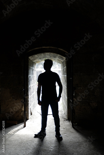 Silhouette of a man in the entrance of a spanish era tunnel in Intramaruos 