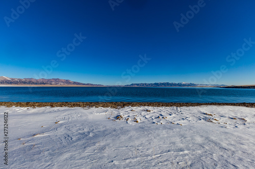 The frozen Sailimu lake with snow mountain background at Yili  Xinjiang of China