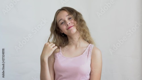 close-up of a teenager girl model with long hair posing on a white background