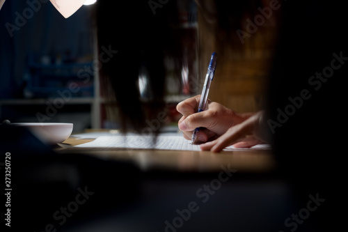 closeup hand writing paper, write something photo