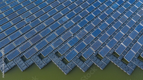 Bild auf Leinwand Solar panels in aerial view, rows array of polycrystalline silicon solar cells or photovoltaics in solar power plant floating on the water in lake