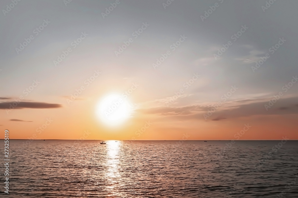 Dramatic atmosphere panorama view of beautiful tropical summer twilight sky and cloud with freshness calm sea and loneliness silhouette boat on golden sunlight.