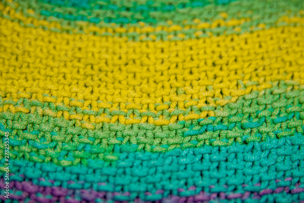 multicolor yellow, green, orange and purple horizontal knitted pattern background