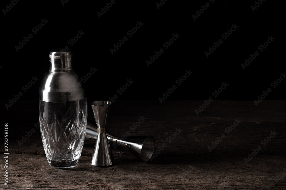 bartender equipment shaker strainer jigger on wood background with copy space