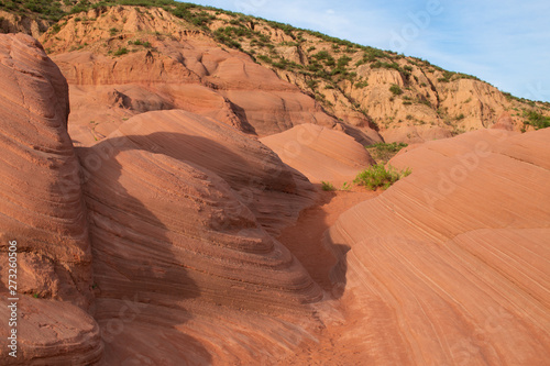 Longzhou Danxia of China, red rocks like waves photo