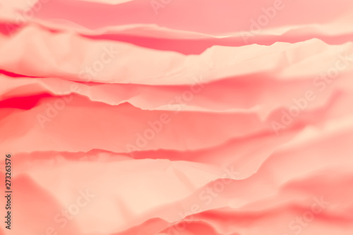 Closeup of coral red paper layers stack. Abstract art background. Blur rose petals effect. Copy space.