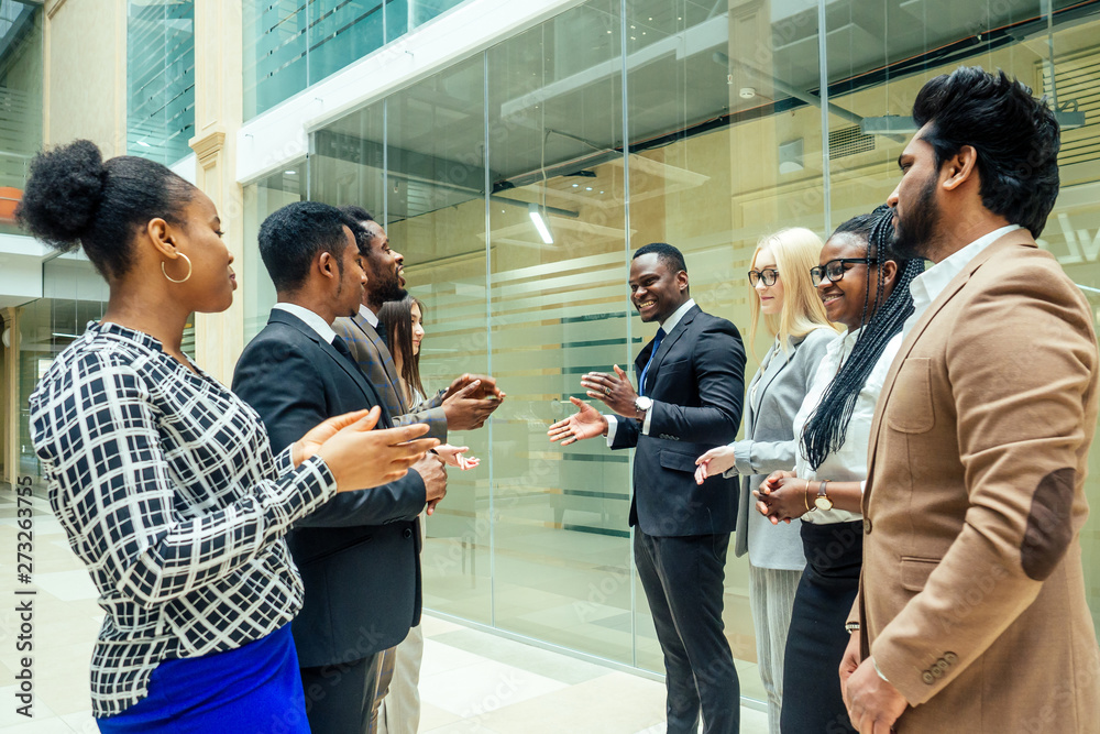 team work group of international business partners : indian,korean, afro-american people working together in modern room team work group of international business partners : indian,korean, afro-american people working together in modern room