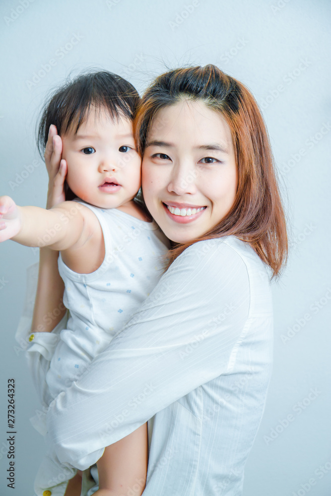 Family, Happy asian mother and baby daughter play in action Family, Happy asian mother and baby daughter play in action