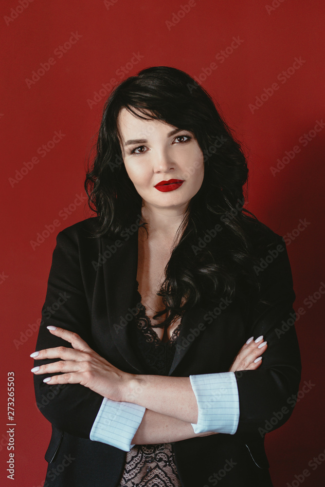 portrait of brunette business woman in suit on red background portrait of brunette business woman in suit on red background
