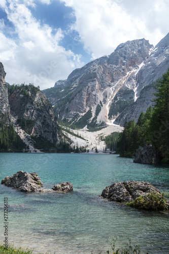 Lake Braies with vivid colors in spring with mountains in the background in the north of Italy