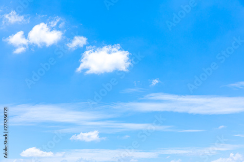 Deep blue sunny sky with white clouds. Blue sky with cloud closeup. White fluffy clouds in the blue sky.