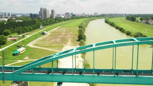 Green Railway bridge over Sava river in Zagreb, Croatia, panoramic view from drone  photo