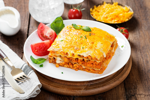 Portion of tasty chicken lasagna with cheddar cheese and bechamel sauce.