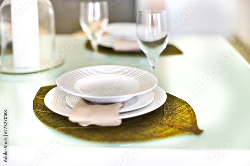 Empty plates on a leaf design and glass