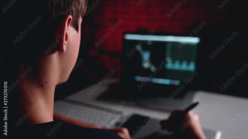 Freelance teen 3d illustrator, content maker, working 3d modelling program and creates a character for further animation on the laptop in house office. Freelance teen 3d illustrator, content maker, working 3d modelling program and creates a character for further animation on the laptop in house office.