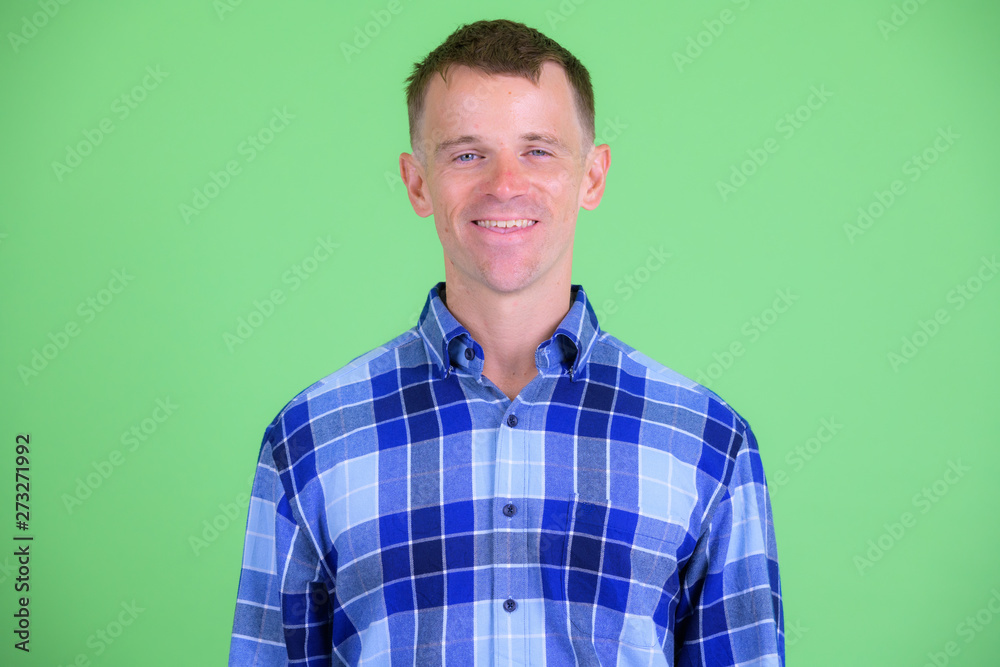 Face of happy hipster man smiling and looking at camera