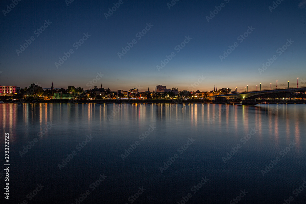 Skyline of a town is reflected in the river