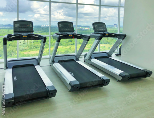 Threadmills in a gym with nature view