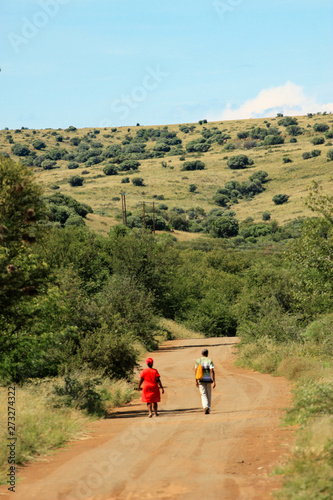 Black couple walking on a country road in South Africa