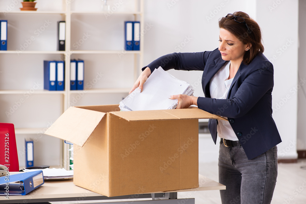 Middle-aged female employee being fired from her work Middle-aged female employee being fired from her work