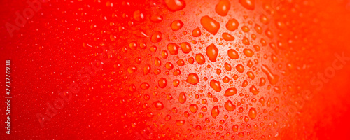 Skin of red ripe tomato with water drops - macro, beautiful culinary background
