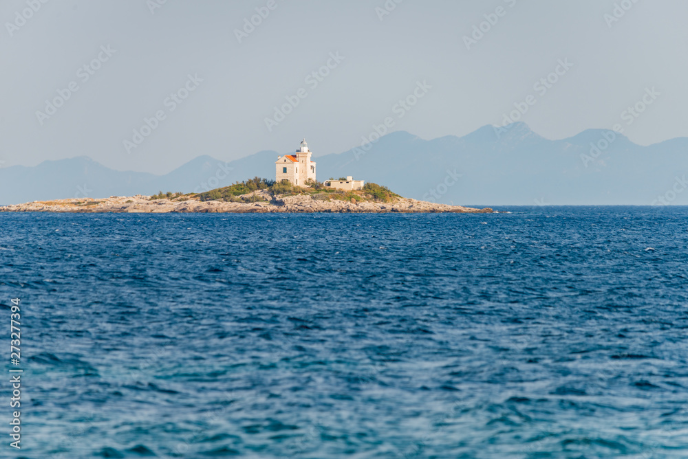 Beautiful summer seascape with lighthouse on the island in Orebic, Peljesac peninsula, Dalmatia, Croatia