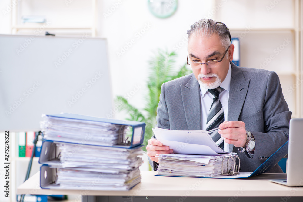 Aged male employee unhappy with excessive work 