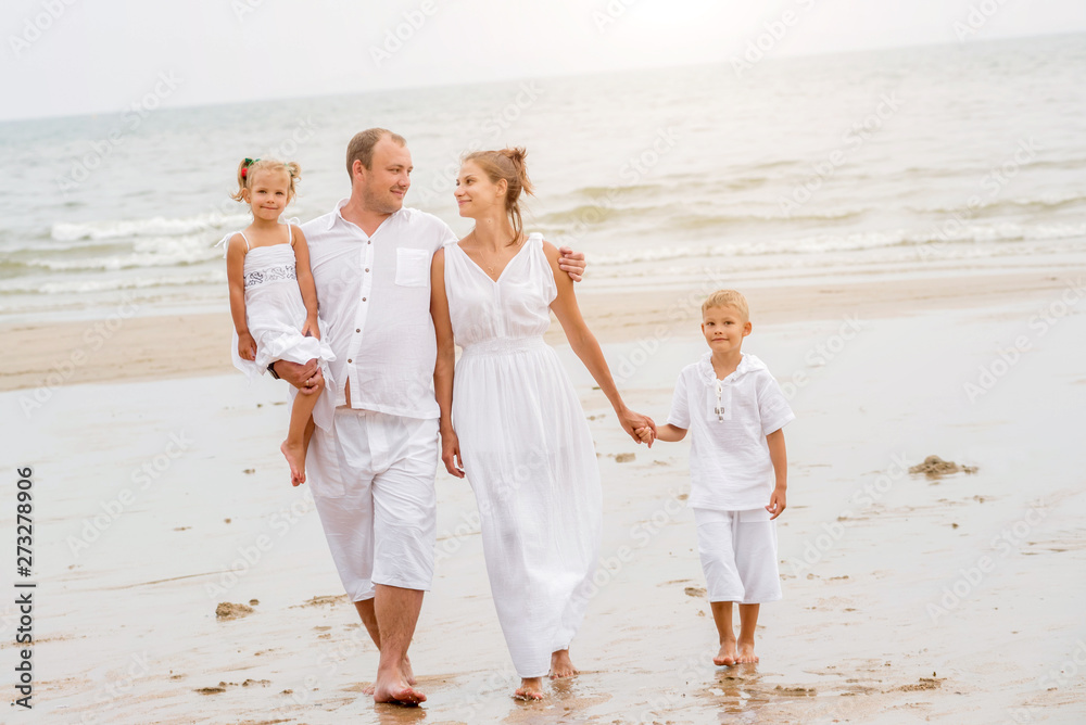 Happy young family on the sunset at the beach. Happy young family on the sunset at the beach.