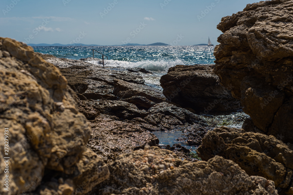 Waves breaking on a stony beach in Murter, Croatia, Dalmatia Waves breaking on a stony beach in Murter, Croatia, Dalmatia