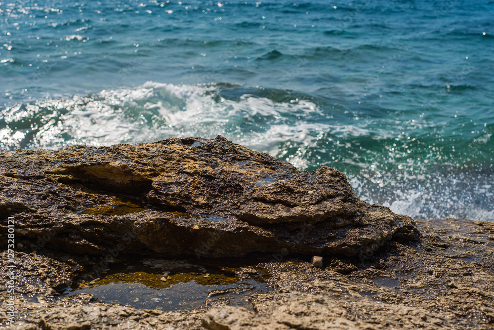 Waves breaking on a stony beach in Murter, Croatia, Dalmatia Waves breaking on a stony beach in Murter, Croatia, Dalmatia