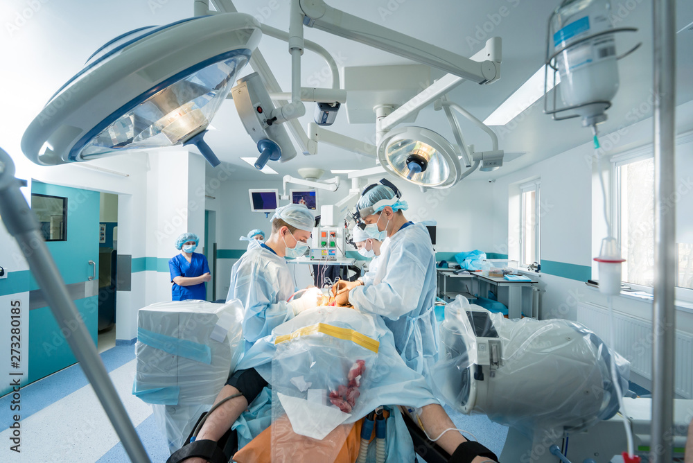 Spinal surgery. Group of surgeons in operating room with surgery equipment. Laminectomy Spinal surgery. Group of surgeons in operating room with surgery equipment. Laminectomy