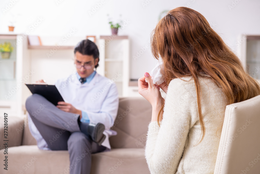 Young female patient discussing with male psychologist personal Young female patient discussing with male psychologist personal